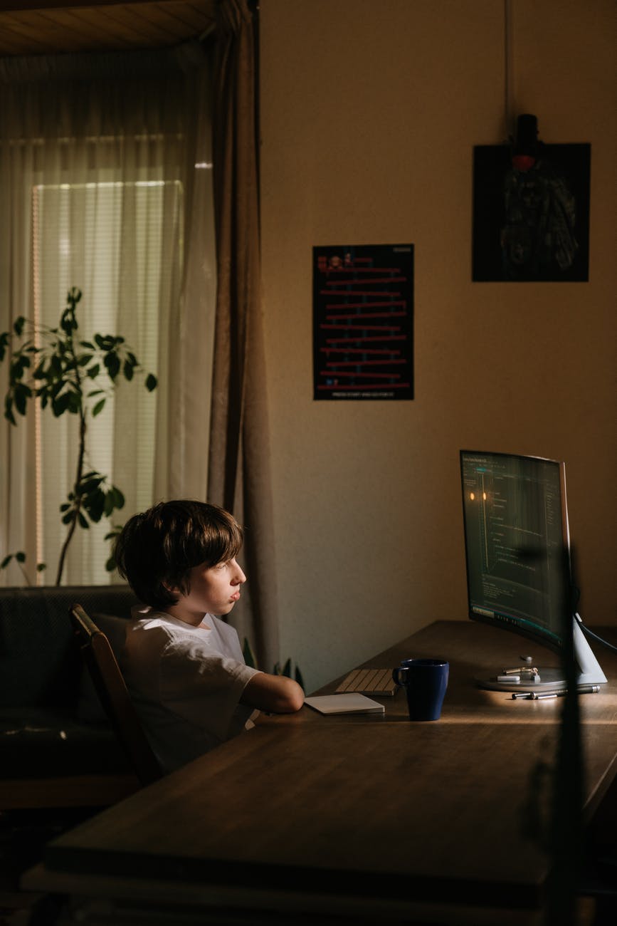 boy in white shirt sitting on chair